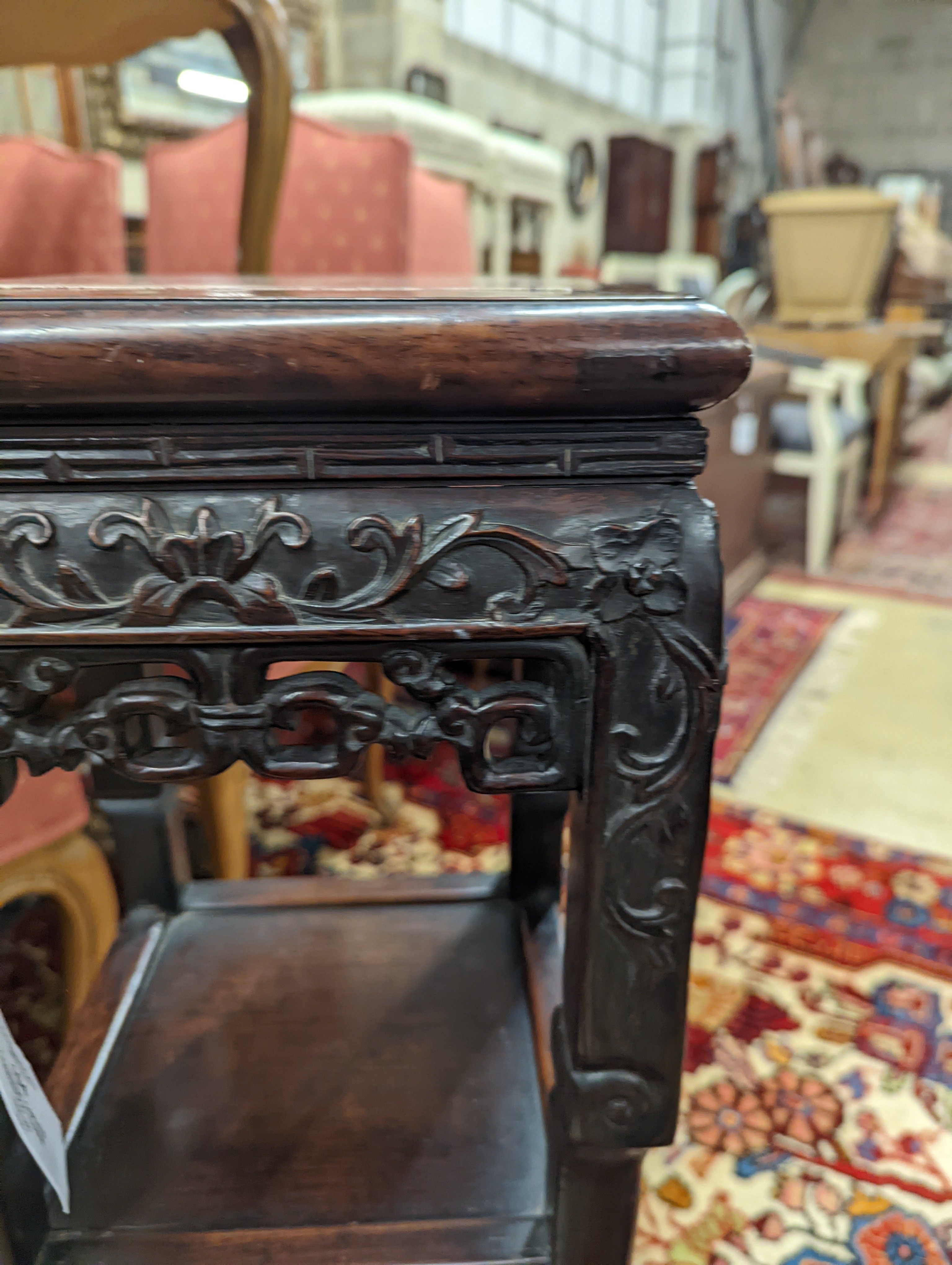 A Chinese carved hardwood three tier jardiniere stand, marble inset, width 22cm, depth 22cm, height 82cm